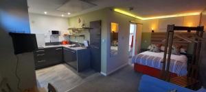 a room with a kitchen and a bedroom with a bed at Thistles Studio - Near Newark & Stubton Hall in Claypole