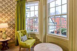 a living room with a chair and a window at Hotel du Vin Henley in Henley on Thames