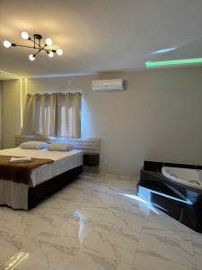 a bedroom with a bed and a ceiling fan at Pousada nascer do sol in Portalegre +6 photos