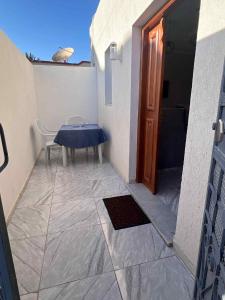 a table and a chair on a balcony with a door at Villa 2 in Al Maqārisah +5 photos