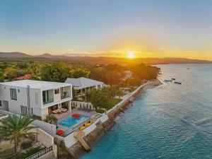 an aerial view of a house on the water at Beachfront Modern Villa with Pool AZURE in Punta Rucia