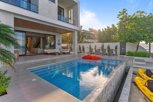 a swimming pool in the backyard of a house at Beachfront Modern Villa with Pool AZURE in Punta Rucia