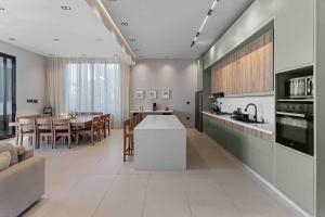 a kitchen and living room with a table and a couch at Beachfront Modern Villa with Pool AZURE in Punta Rucia