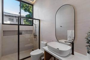 a bathroom with a sink and a mirror at Beachfront Modern Villa with Pool AZURE in Punta Rucia +32 photos