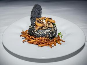 a doughnut with mushrooms on a white plate at Wellness Hotel Jean De Carro in Karlovy Vary +64 photos