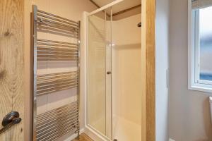 a glass shower in a bathroom with a window at Sandy Lane 18 - Lodge with Hot Tub in Allerthorpe +17 photos