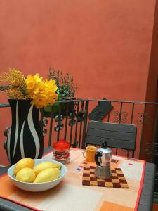 a table with a bowl of food and a vase with flowers at Da Greta - Biassa in La Spezia +28 photos