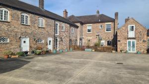a large brick building with a driveway in front of it at The Pheasant in Broseley +13 photos