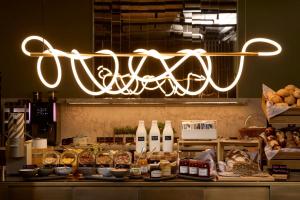 a chandelier hanging over a counter in a bakery at The Cloud One Frankfurt-Metropolitan in Frankfurt
