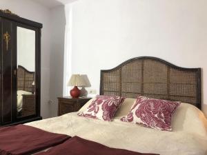 a bed with two pillows on it in a bedroom at Las Casitas de Layos in Layos