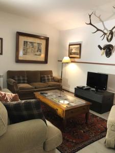 a living room with a couch and a coffee table at Las Casitas de Layos in Layos