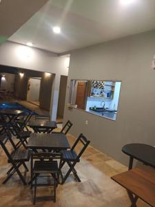 a restaurant with tables and chairs in a room at Rekanto Sabiá in Jijoca de Jericoacoara