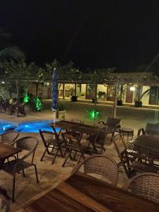 an outdoor patio with tables and chairs at night at Rekanto Sabiá in Jijoca de Jericoacoara