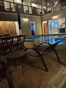 a pool with tables and chairs next to a swimming pool at Rekanto Sabiá in Jijoca de Jericoacoara