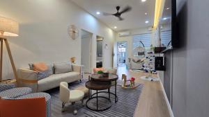 a living room with a couch and a table at Skudai - The9 Homestay 1min UTM, near Sutera Mall, Paradigm Mall, Senai airport in Skudai
