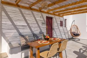 a dining room with a table and chairs at Glaucus Summer House sea view in Mandrakia