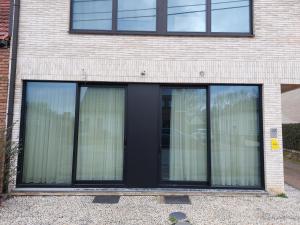 a window with black trim on a brick building at Comfy Stay 9052 in Ghent