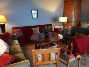 a living room with a couch and a table at Villa Fjara sleeps 22 in 6 bedrooms in Ulven