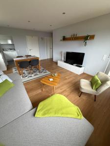 a living room with a couch and a table at Ferienwohnung Carina in Losheim