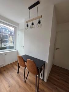 a dining room with a black table and two chairs at Cozy downtown studio in Schwäbisch Hall