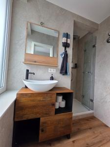 a bathroom with a sink and a mirror at Cozy downtown studio in Schwäbisch Hall