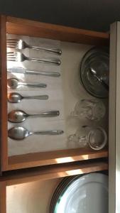 a drawer filled with silver utensils in a kitchen at Layans Properties in Gampaha