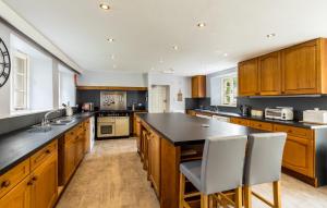 a kitchen with wooden cabinets and a black counter top at Elterwater Park self catering in Ambleside