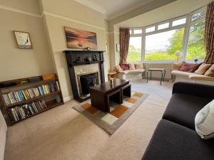 a living room with a fireplace and a couch at Elterwater Park self catering in Ambleside