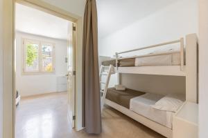 a room with two bunk beds and a doorway at Cava Li Santi Residence a Santa Caterina in Nardò