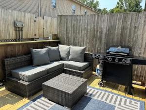 a patio with a couch and a grill at Alumni Corner in State College