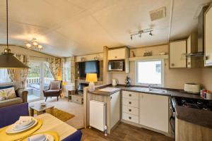 a kitchen and living room of a caravan at The Major Oak Lodge with Hot Tub in York