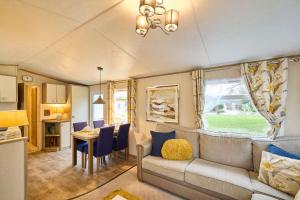 a living room with a couch and a table at The Major Oak Lodge with Hot Tub in York +22 photos