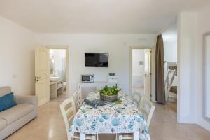 a living room with a table and a couch at Cava Li Santi Residence a Santa Caterina in Nardò +75 photos