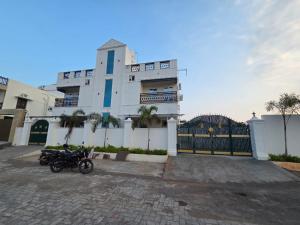 a building with two motorcycles parked in front of it at Bluebell castle in Mahabalipuram