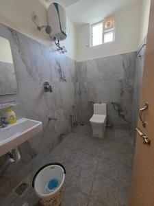 a bathroom with a toilet and a sink at Bluebell castle in Mahabalipuram +15 photos