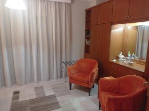 a room with a table and two chairs and a mirror at SOUROTI Pinios House in Sourotí