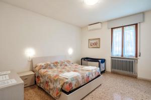 a bedroom with a bed and a window at Villa Ferri in Peschiera del Garda