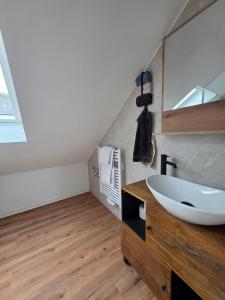 a bathroom with a sink and a mirror at Modern apartment in downtown in Schwäbisch Hall