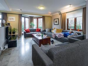 a boy laying on a couch in a living room at Group accommodation in Borgloon Hof Van Kalenberg in Borgloon