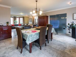 a dining room and living room with a table and chairs at Group accommodation in Borgloon Hof Van Kalenberg in Borgloon