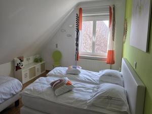 a bedroom with two beds and a window at Group accommodation in Borgloon Hof Van Kalenberg in Borgloon