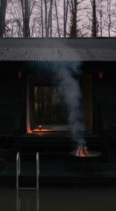 a house with a fire in front of it at Yogi's Cabin in Battle