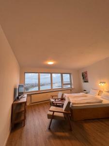 a bedroom with a bed and a desk and a window at Inselblick 3 in Schleswig