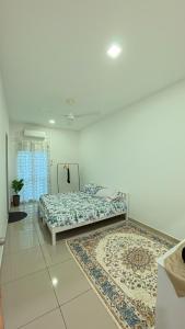 two beds in a room with two rugs at Hm home 2 in Sepang +17 photos