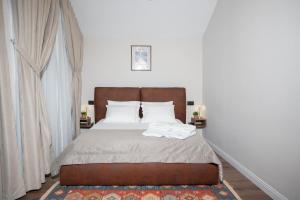 a bedroom with a bed with two towels on it at Villa Garden Boutique Hotel Tirana in Tirana