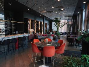 a restaurant with a table and chairs and a bar at Clarion Hotel Oslo in Oslo