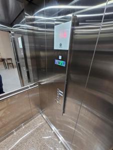 a metal elevator with a sign on the side of it at Hotel Bellavista in Paulo Afonso +20 photos