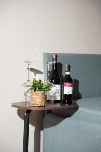 two bottles of wine and a plant on a table at Villa Garden Boutique Hotel Tirana in Tirana