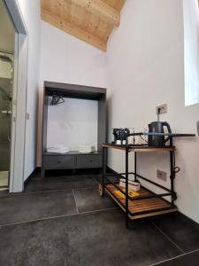 a kitchen with a table and a mirror at B&B Le Origini in Ledro
