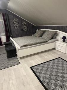 a bedroom with a bed and a chair and a table at Modern mitten in der Stadt und doch sehr ruhig 2 Minuten zu Therme in Bad Ems